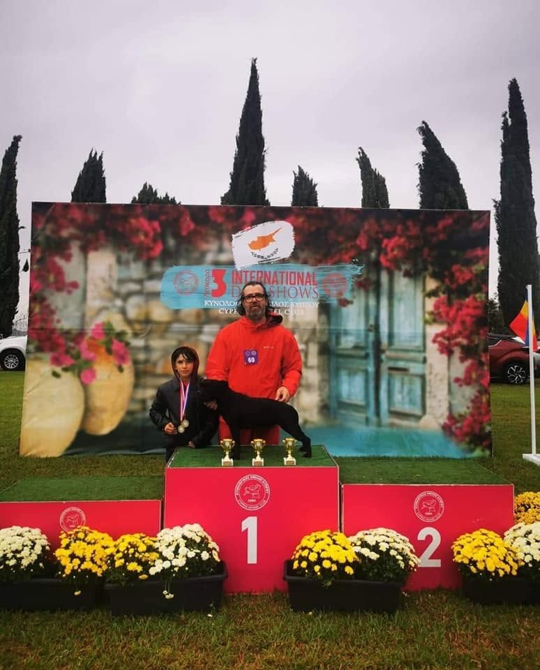 Mooncraft's Kiss and Play on the first-place podium at the Cyprus Kennel Club International Dog Shows, October 2022