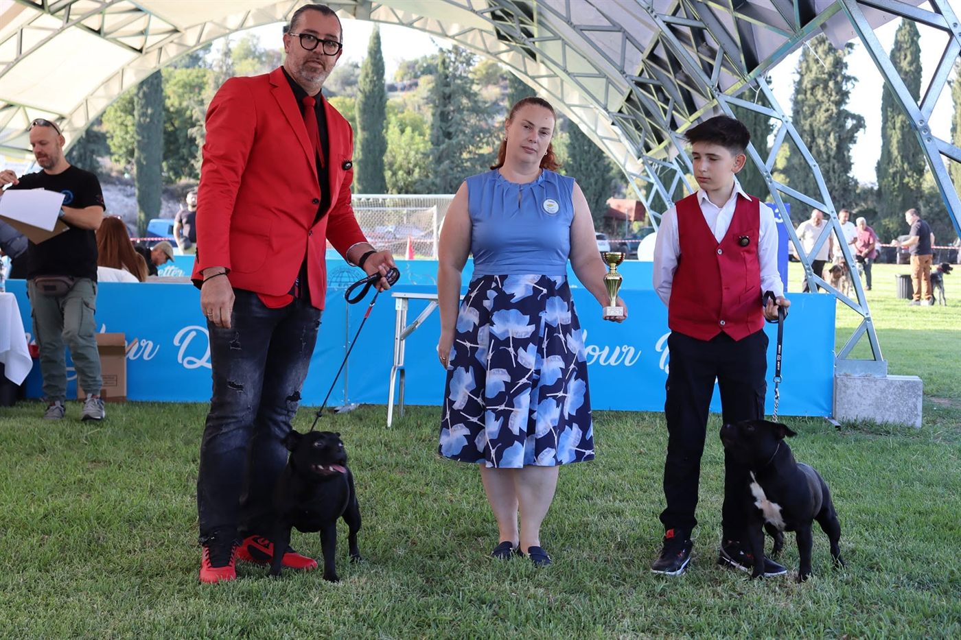 Two AFG Staffordshire Bull Terriers with the judge holding the trophy