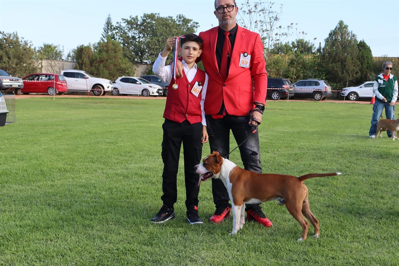 Young handler with a medal beside an AFG American Staffordshire Terrier